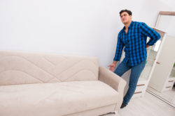 Man is adjusting sofa