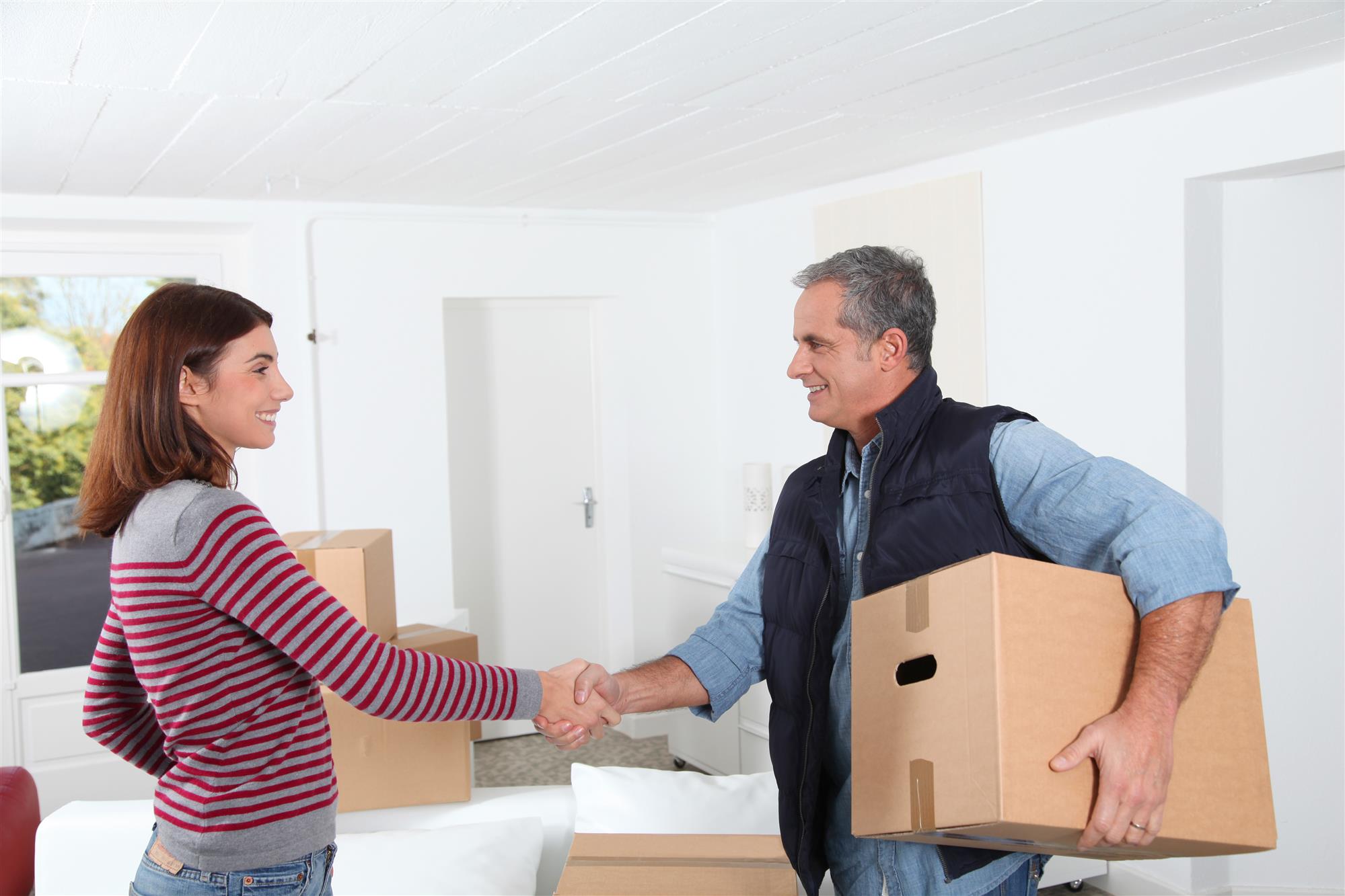 man holding storage box shaking hands with woman