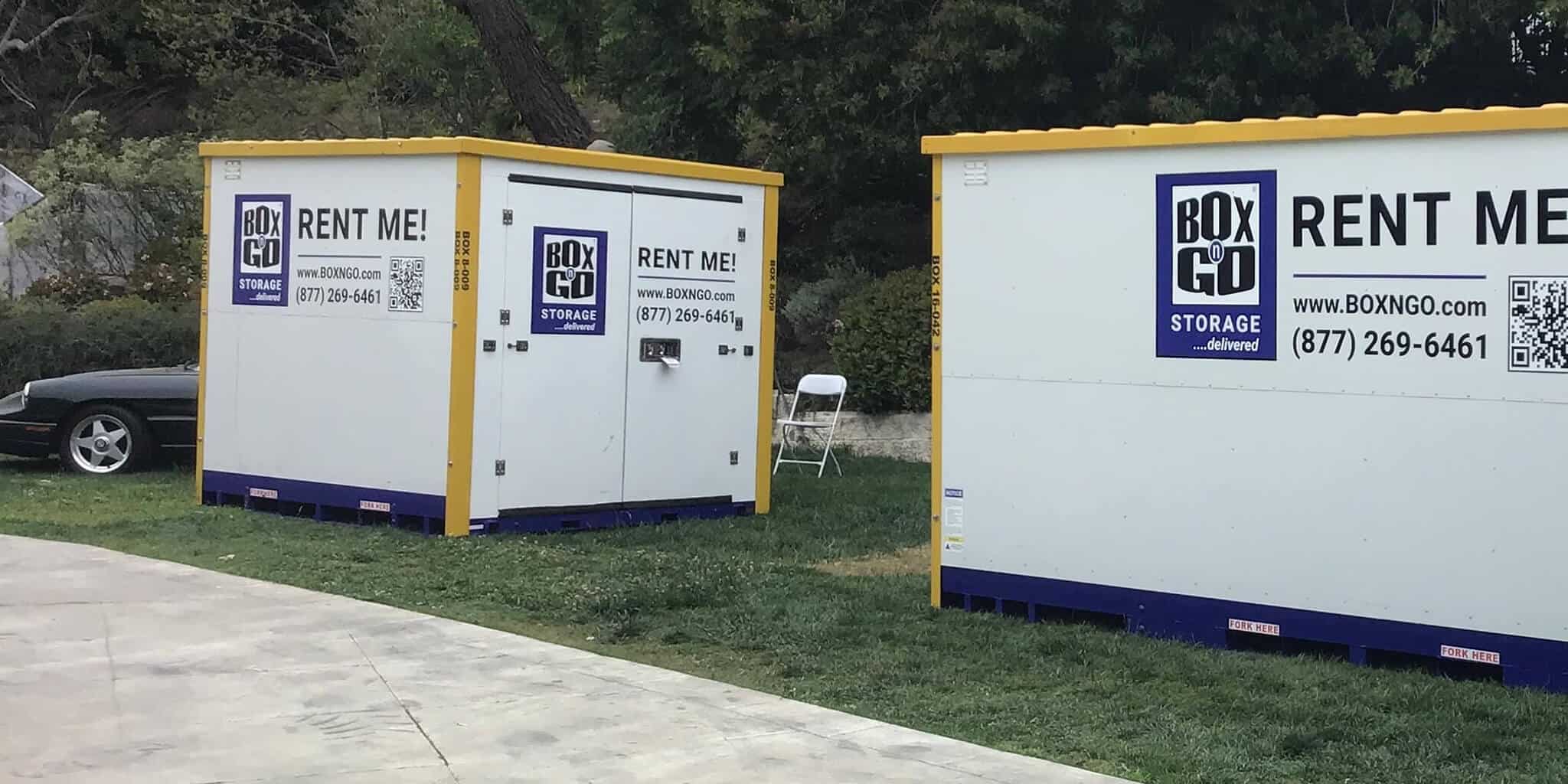 Two Box-n-Go storage containers on grass near a sidewalk in Mid-Wilshire, Los Angeles