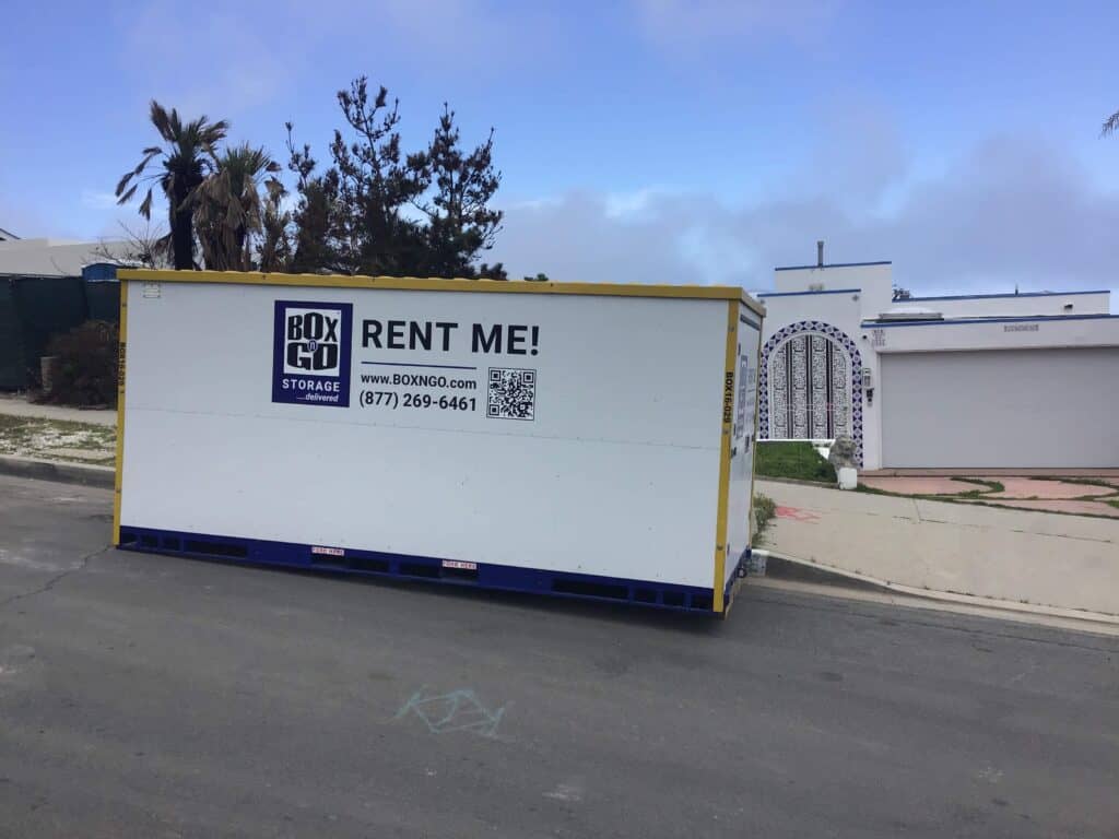 Box-n-Go storage container placed on a residential street in Santa Monica, near a white house with a decorative arched gate.