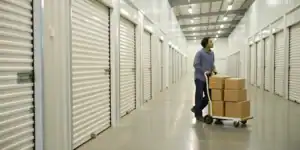 Business storage facility hallway with rolling cart of boxes.