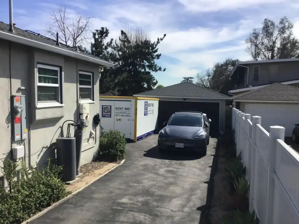 Box-n-Go mobile storage container in Baldwin Hills driveway with Tesla; ideal for self storage 90046, 90048, 90069, climate-controlled and student storage near UCLA.