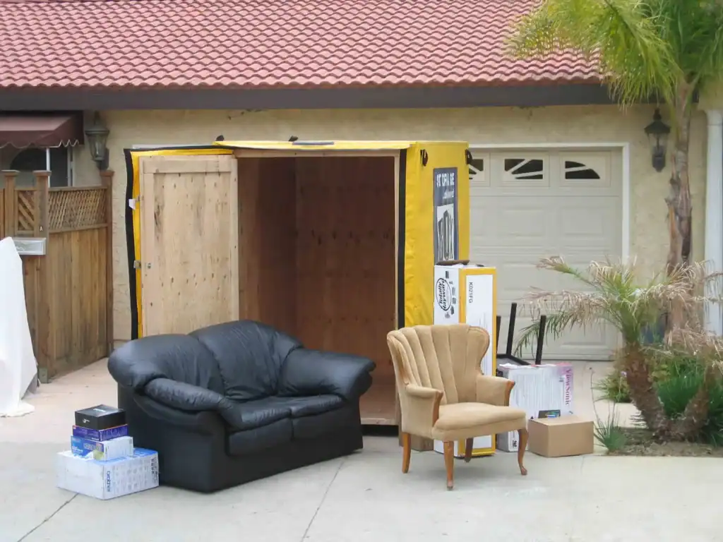 Apartment Movers in Los Angeles CA - Two movers are actively loading Box-N-Go portable storage containers with boxes and furniture, showcasing efficient apartment moving and storage services.