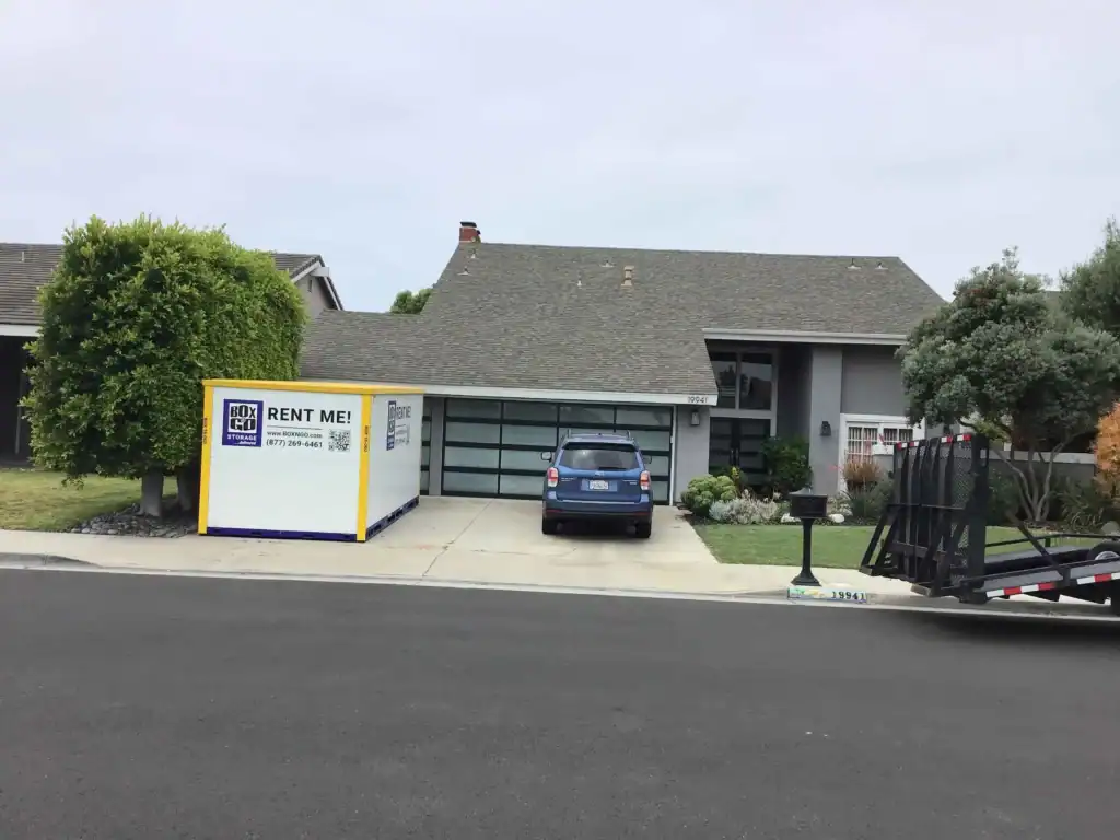 Box-n-Go portable container in a residential driveway providing convenient self storage in Bell Gardens CA for moving and household storage solutions.
