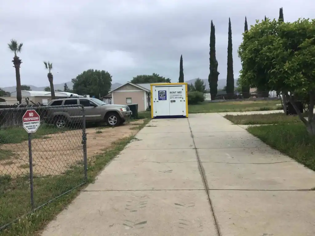Box-n-Go portable container on a residential driveway providing secure and convenient self storage in Bell Gardens CA for households and businesses.