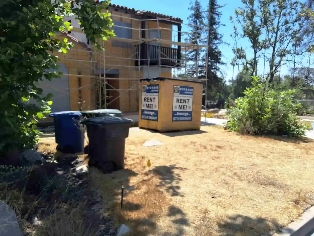 Box-n-Go portable container placed outside a residential property under renovation offering flexible self storage in Bell Gardens CA for homeowners and contractors.