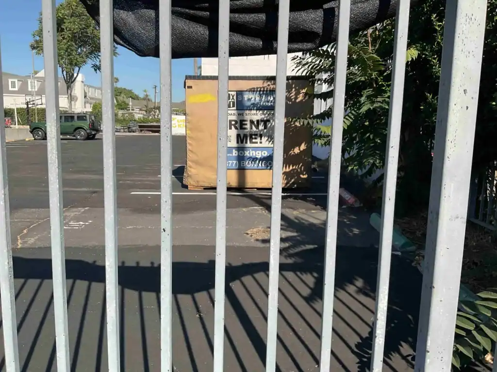 Box-n-Go portable self storage container placed in a gated parking lot in Bellflower CA, offering secure and affordable self storage solutions for residents and businesses.