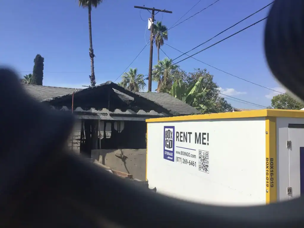 Box-n-Go portable self storage unit in front of a residential property in Bellflower CA, providing secure and flexible self storage solutions for homeowners and businesses.