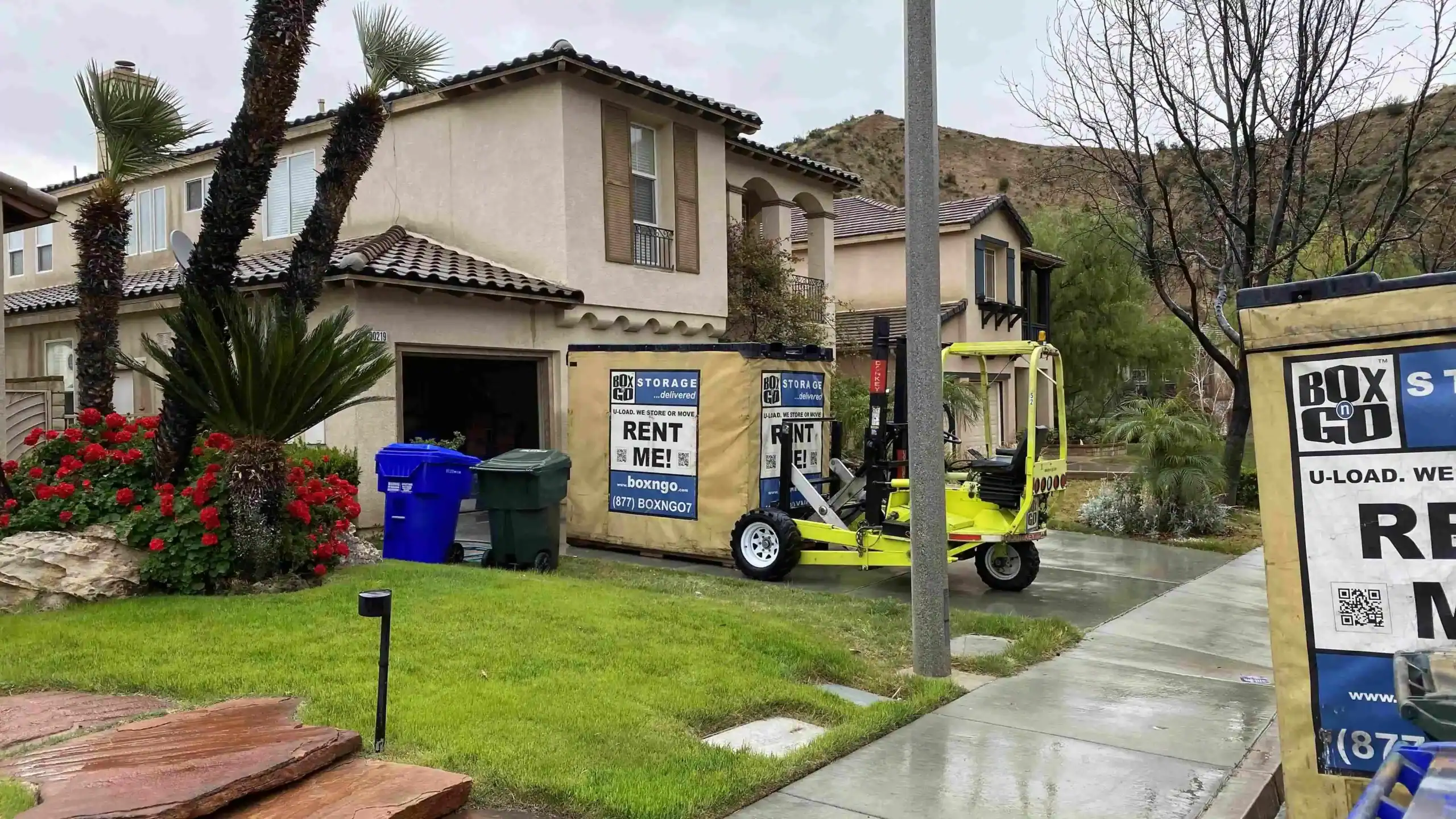 Box-n-Go portable storage container delivered to a suburban home driveway, providing residents with secure and convenient Self Storage in Bell CA.