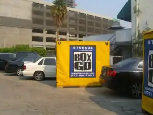 Box-n-Go portable storage containers for office inventory storage in West Hollywood, placed in a secure urban parking lot with surrounding office buildings.