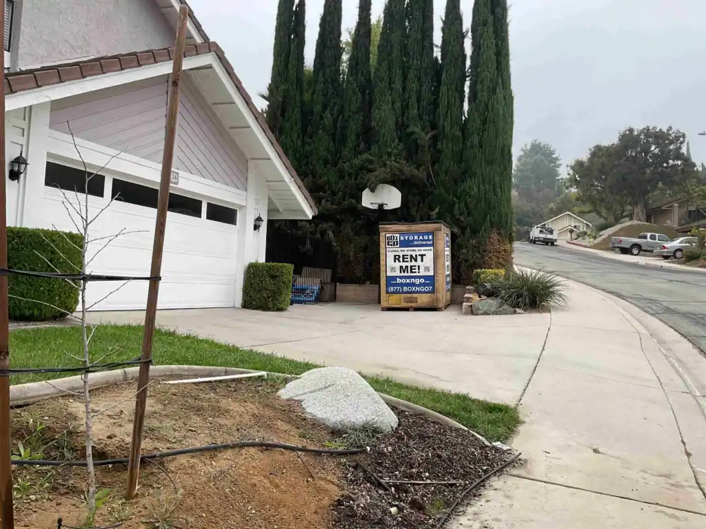 Box-n-Go portable storage unit in front of a suburban home, providing secure and flexible self storage in Norwalk CA.