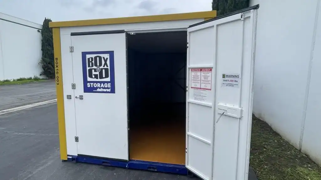 Empty storage container from Boxngo, ready to be loaded by movers that load containers for storage or relocation. The container is placed in a secure location, offering a convenient solution for moving and storing belongings.