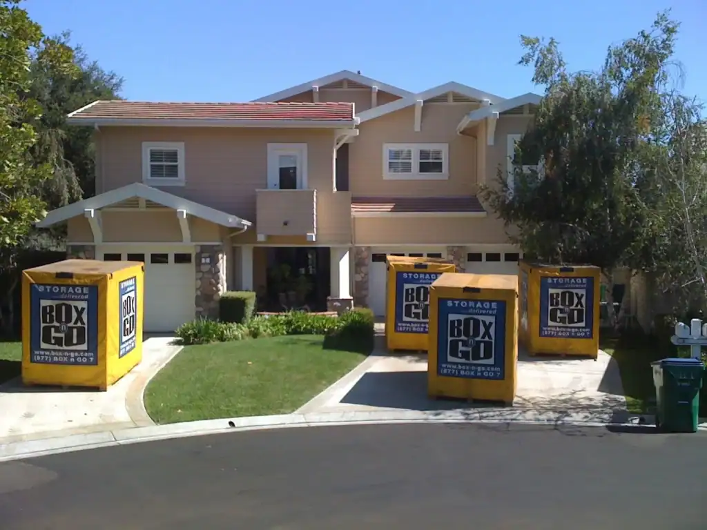 Home renovation storage solution featuring multiple BoxGo storage containers parked in a driveway. These portable storage units provide a convenient and secure option for storing belongings during a home renovation project.
