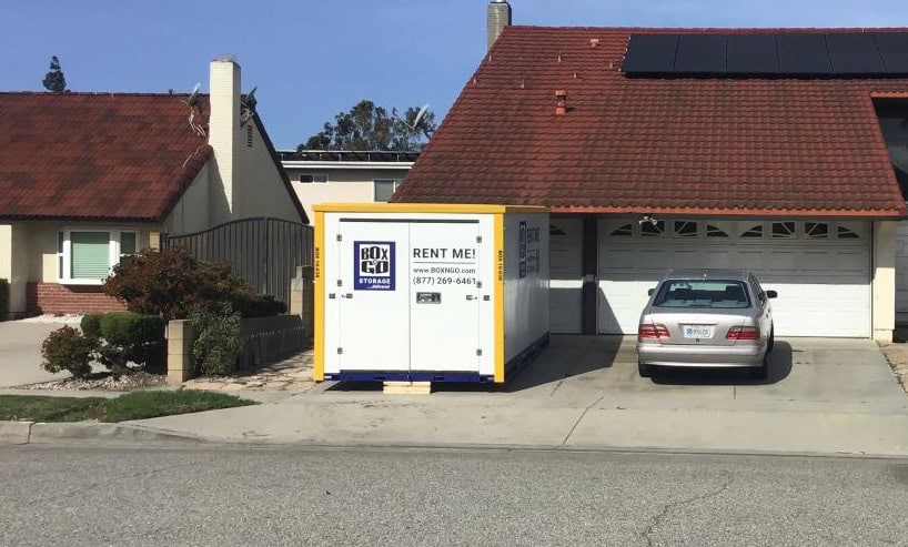 Playa Del Rey Movers delivering a portable storage container from Box-n-Go to a residential driveway in Playa Del Rey, CA, for easy and secure moving and storage solutions.
