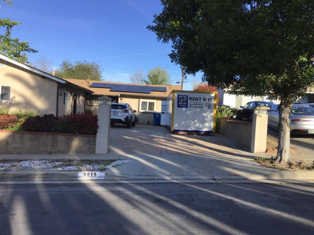 Playa Del Rey Movers providing a Box-n-Go portable storage unit at a residential driveway in Playa Del Rey, CA, offering convenient and affordable moving and storage solutions for local homeowners.