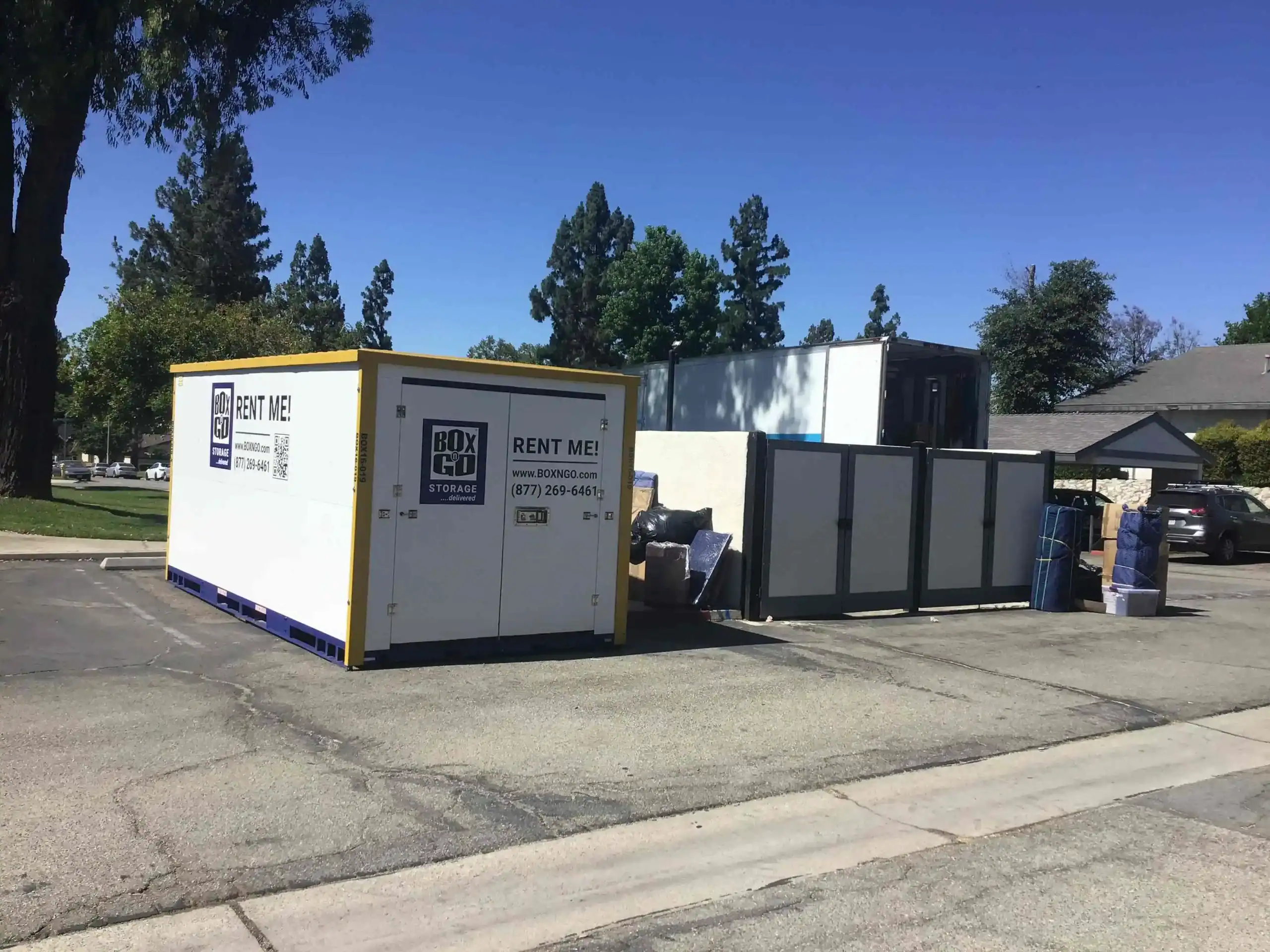 Portable storage containers and moving boxes in a Santa Monica neighborhood, illustrating practical decluttering tips Santa Monica residents can use for organizing, storing, and simplifying home spaces.