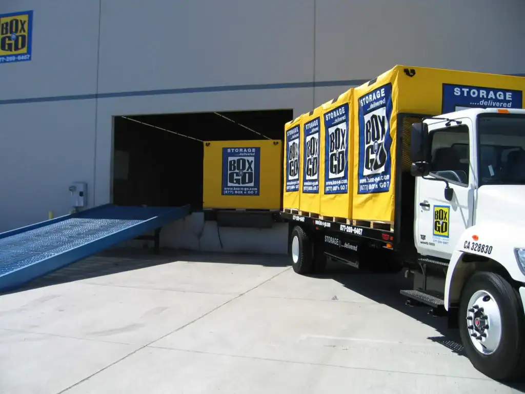 Portable yellow storage containers from Box-n-Go placed outside a residential property, ideal for convenient and flexible Self Storage in Boyle Heights CA.