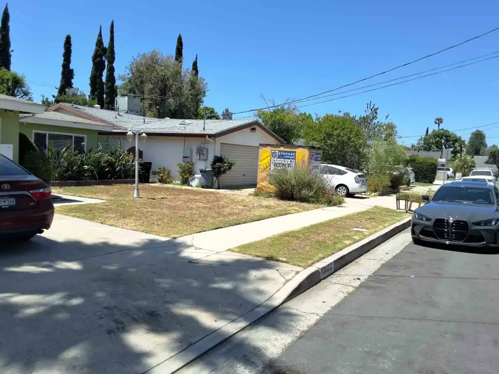 Residential home in Santa Monica with portable storage container on driveway, showing practical decluttering tips Santa Monica homeowners can use for organizing and simplifying living spaces.