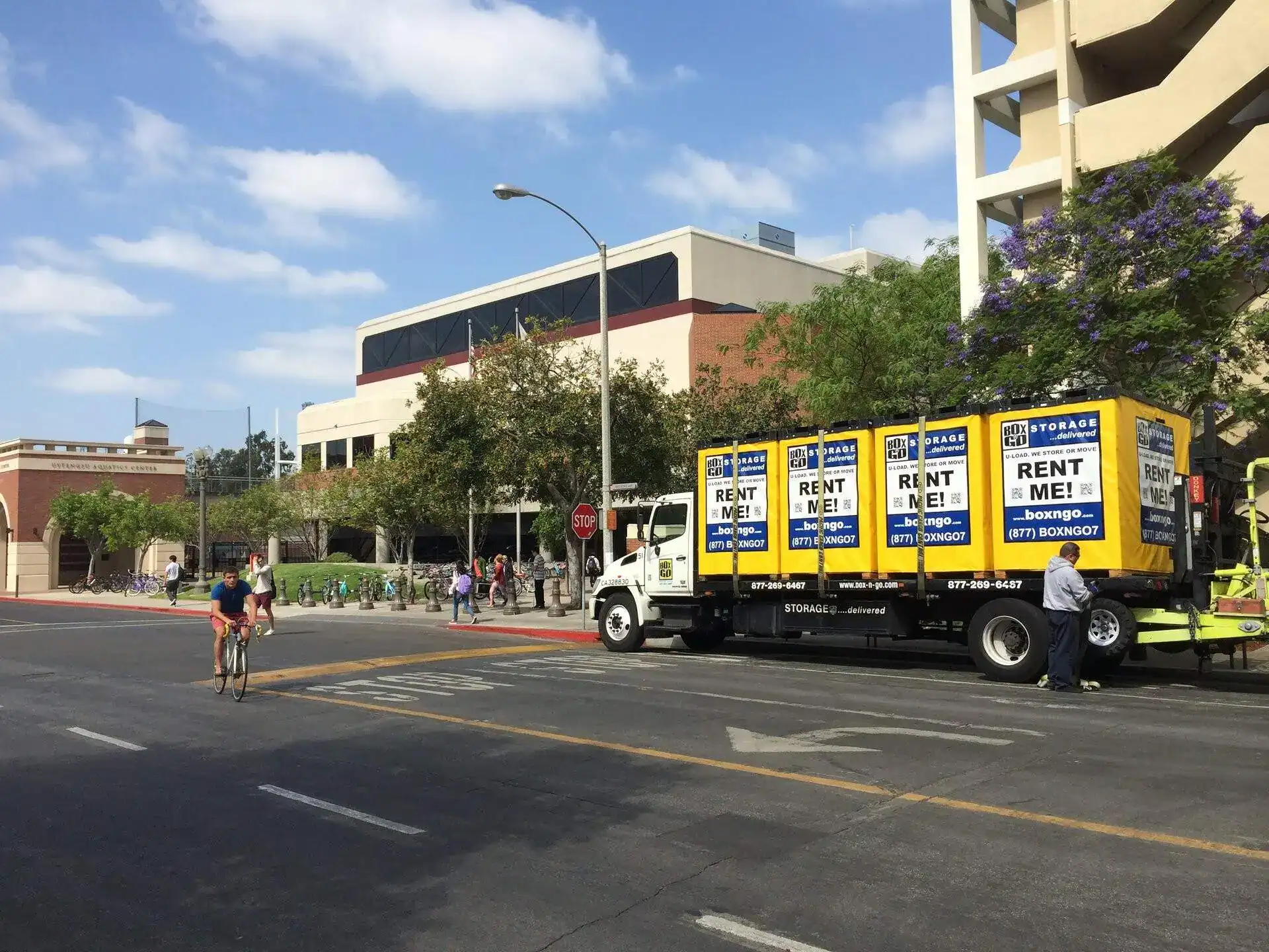 Truck delivering Box-n-Go portable student storage units near a university campus, offering convenient and affordable student storage near West Hollywood for college move-in and summer storage needs.