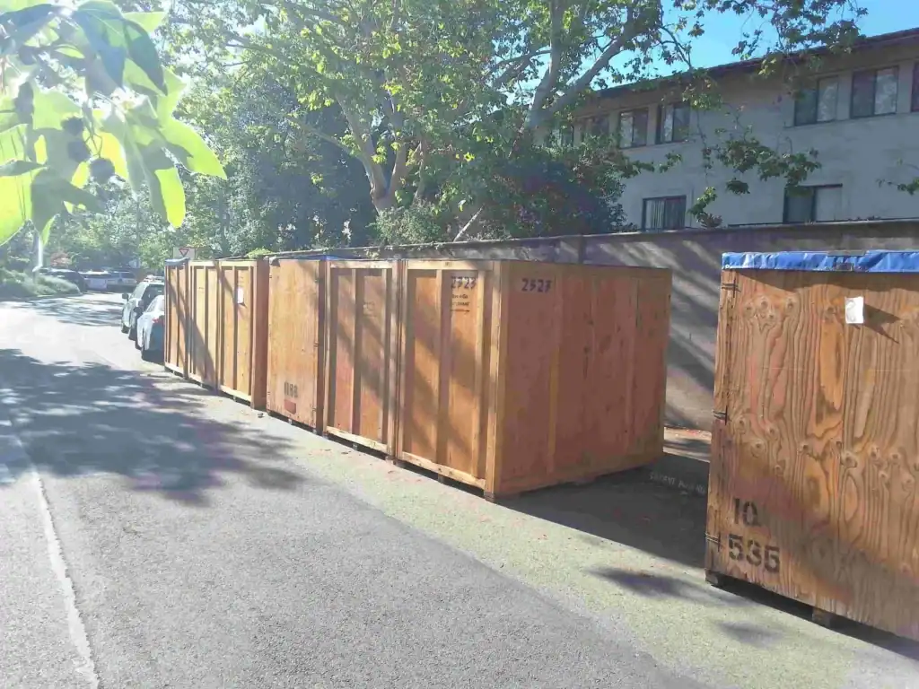 Wooden storage containers lined up on a residential street in Santa Monica, demonstrating effective decluttering tips Santa Monica residents can use for organizing and storing household items.