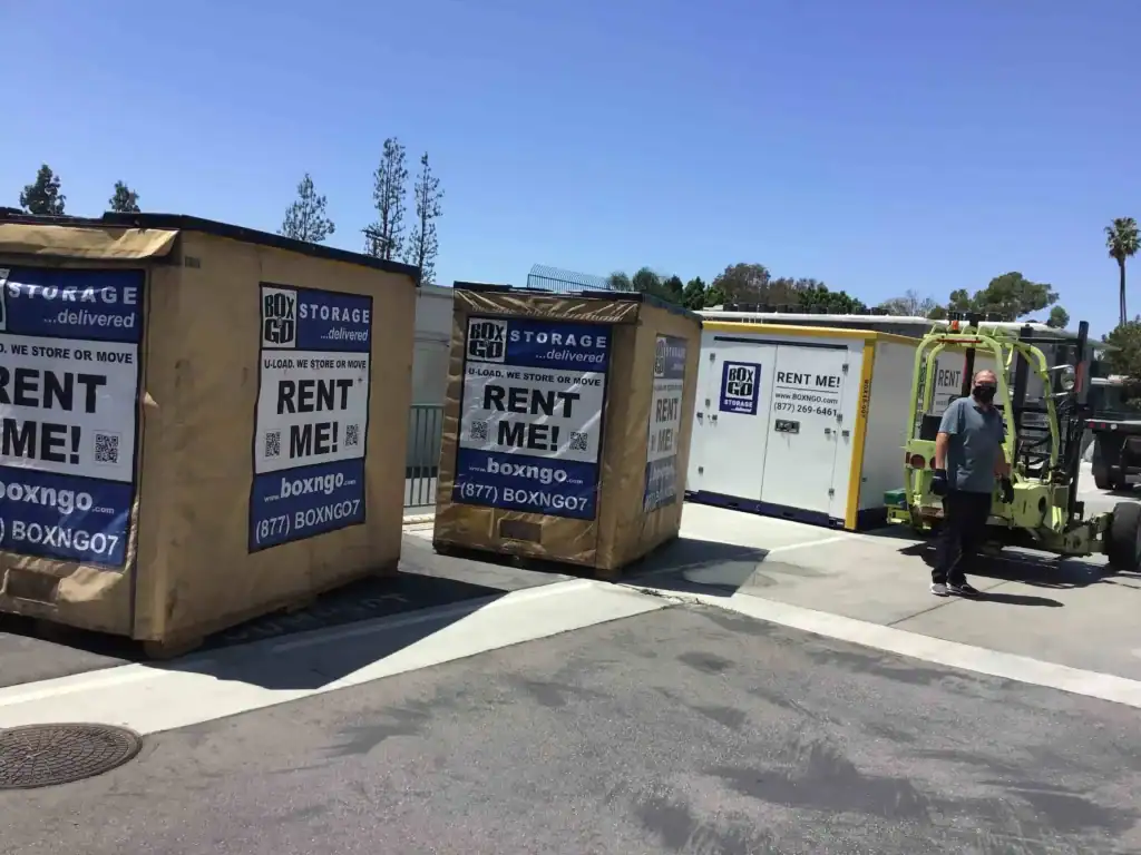 Portable storage containers being delivered with a forklift, highlighting convenient and affordable self storage in Cudahy CA for moving and storage needs.