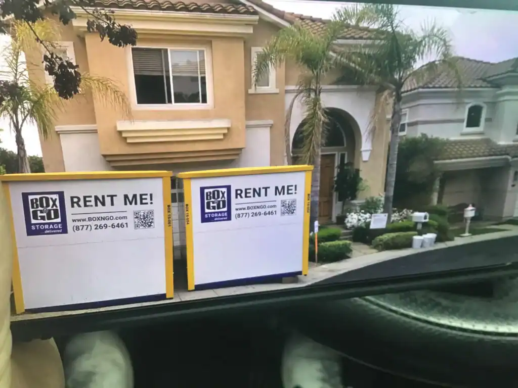 Two portable storage containers in front of a home, showcasing convenient self storage in Cudahy CA for moving, remodeling, and household organization.