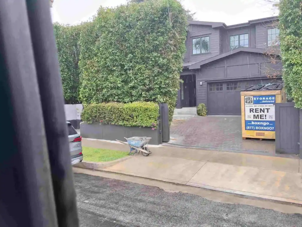 Residential driveway with portable self storage in Huntington Park CA, convenient rental storage container for moving and home organization.