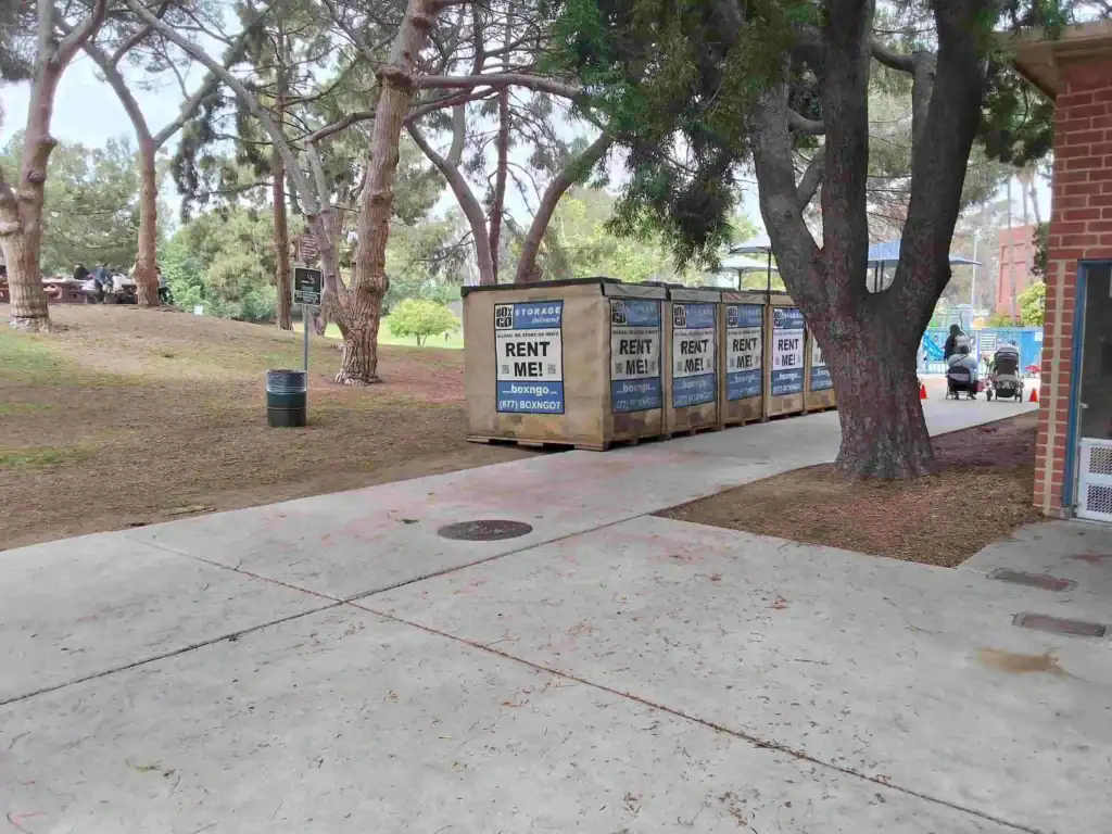 Portable Box-n-Go storage containers placed in a park setting offering flexible and affordable self storage in Huntington Park CA for residents and businesses.