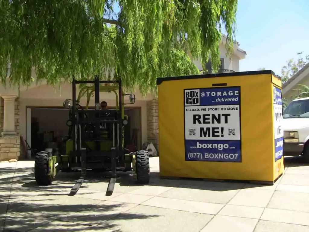 Box-N-Go portable self storage Venice container outside residential garage.