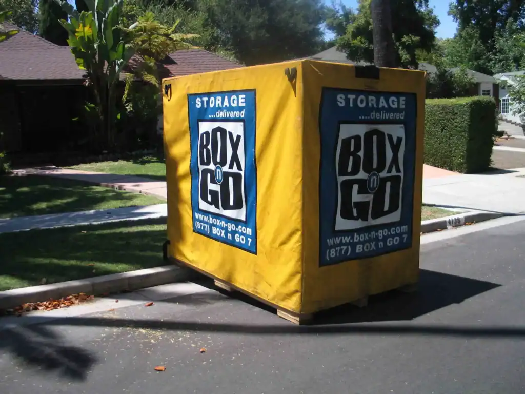 A yellow Box-n-Go portable storage container on a residential street, perfect for short term storage solutions in Sherman Oaks.