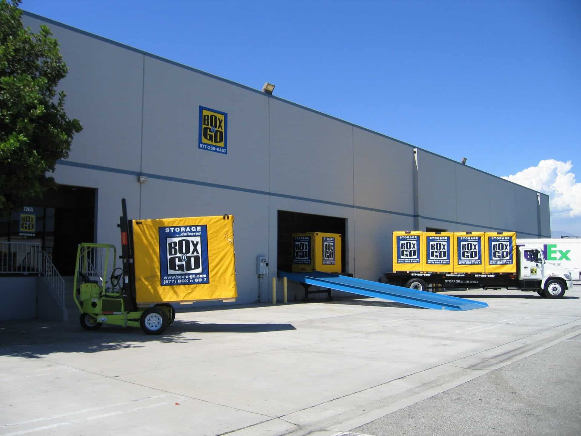 Box-n-Go facility providing long term storage in Santa Monica with portable storage containers being loaded and delivered for convenient storage solutions.