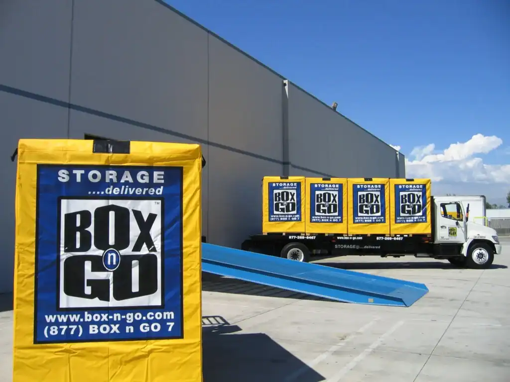 Box-n-Go portable storage Venice Beach with secure yellow storage containers loaded on a delivery truck, offering convenient mobile storage solutions for homes and businesses.