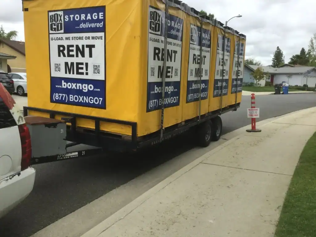 Box-n-Go portable storage containers loaded on a trailer for delivery, highlighting convenient storage container rental in West Hollywood for moving and secure storage needs.