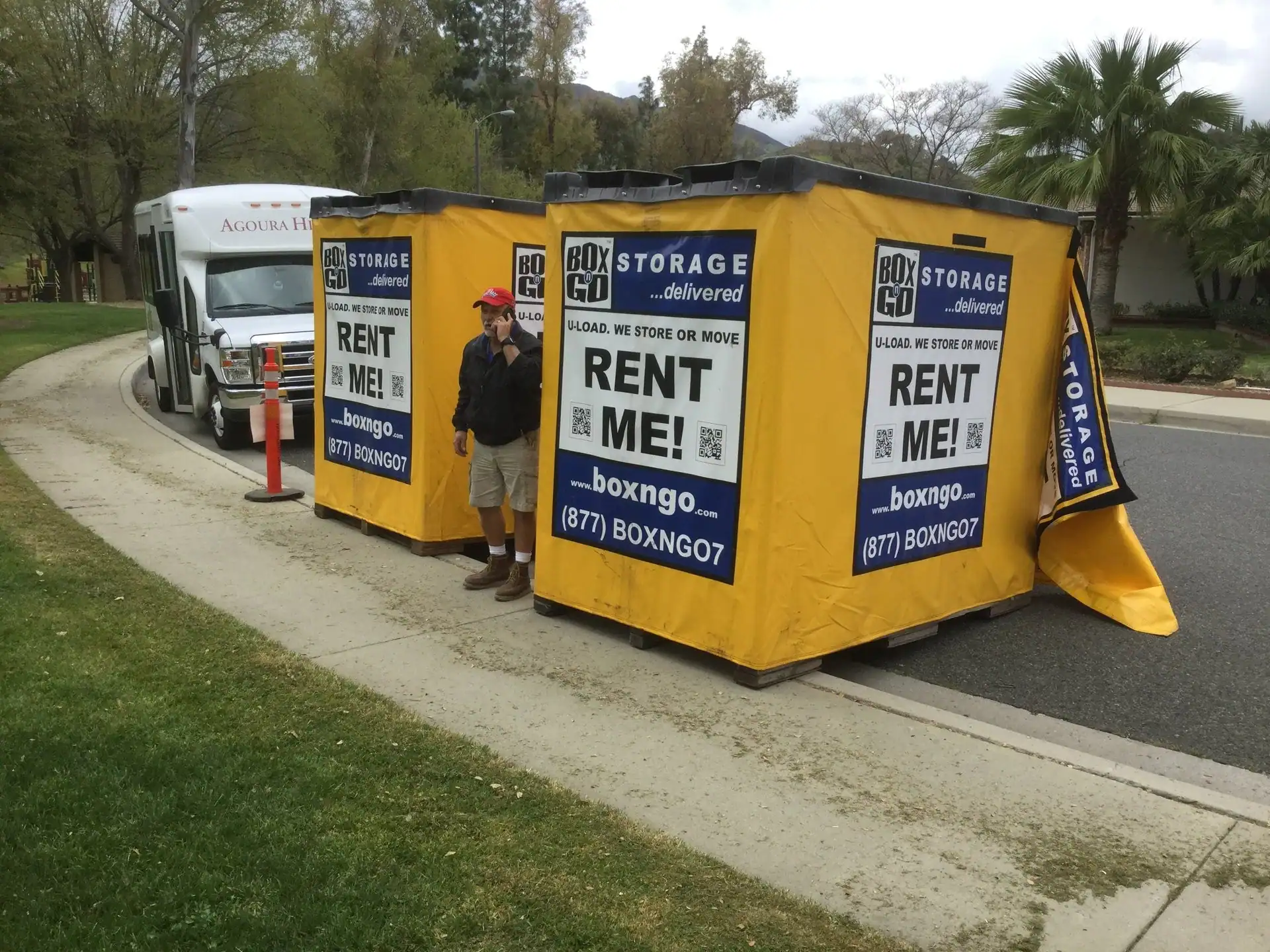 Box-n-Go portable storage containers on a sidewalk, ideal for trade show booth storage, offering secure and convenient rental solutions for events and exhibitions.