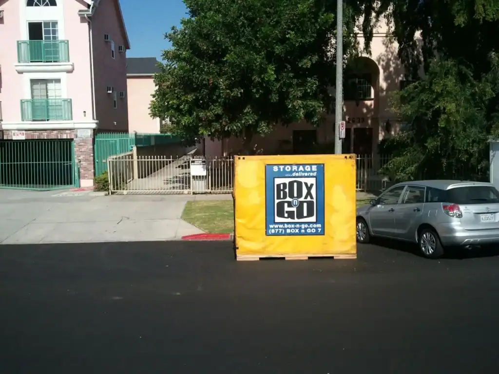 Box-n-Go yellow moving container placed in front of a residential building in Sherman Oaks, ideal for hassle-free moving containers and storage solutions in the area.