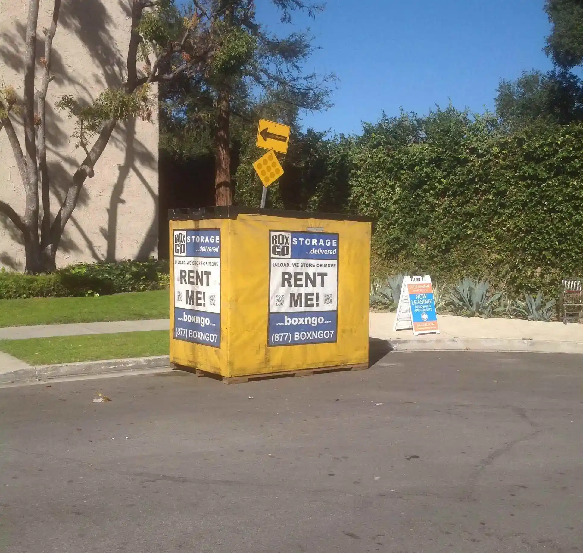 Bright yellow portable storage container from Box-n-Go placed on a residential street, promoting convenient and affordable Self Storage Units in Burbank CA for local moving and storage needs.
