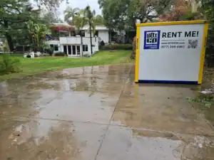 Business storage Venice solution with a Box-n-Go portable storage unit placed on a residential driveway in a lush green yard, ideal for commercial or home use in Venice, California.