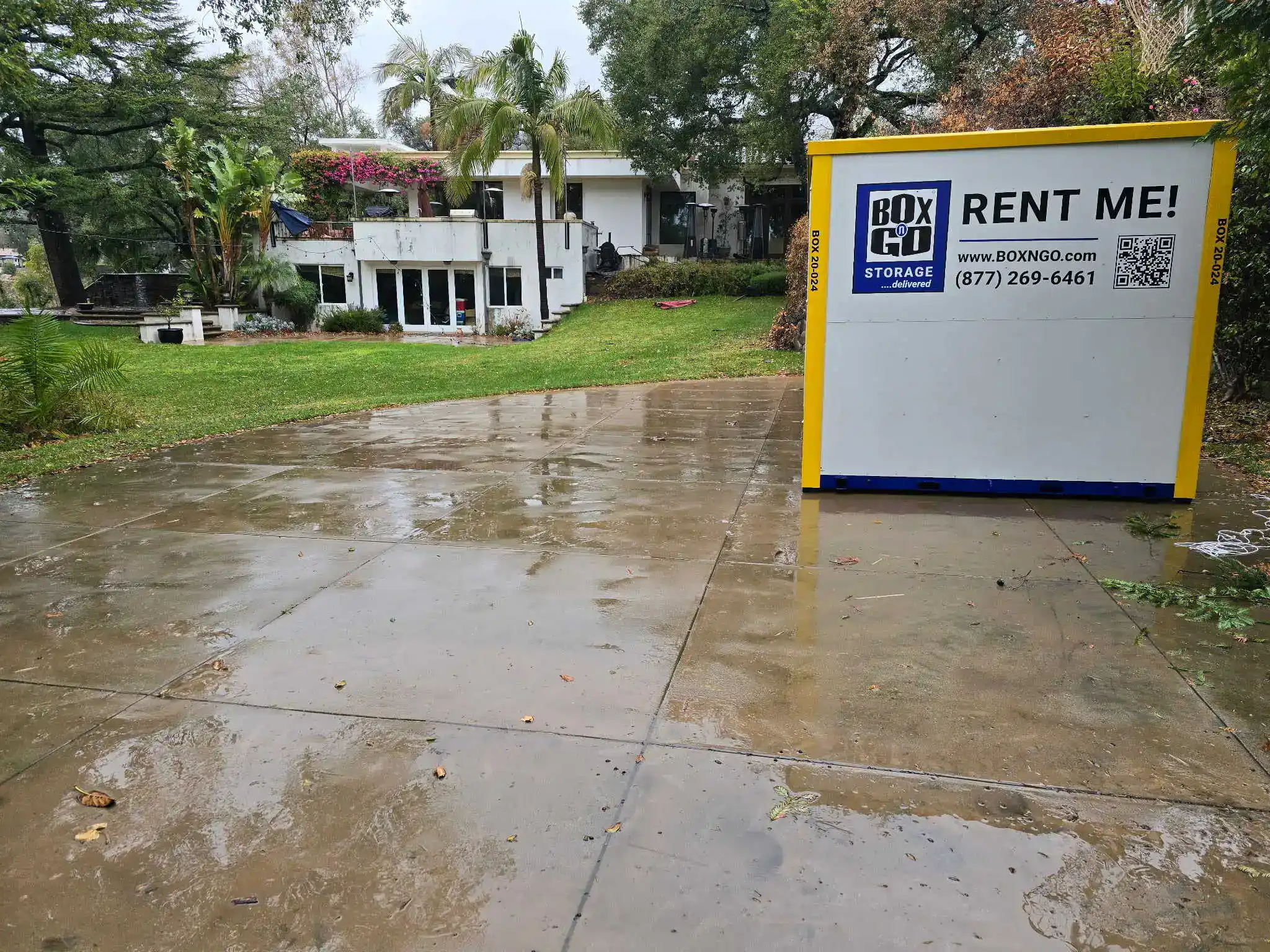 Business storage Venice solution with a Box-n-Go portable storage unit placed on a residential driveway in a lush green yard, ideal for commercial or home use in Venice, California.