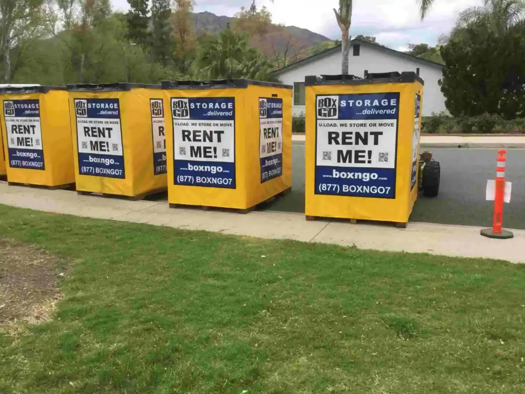 Multiple yellow Box-n-Go portable containers lined up on a suburban street, showcasing convenient and affordable Self Storage Unit in Calabasas CA for moving, renovation, and home storage solutions.