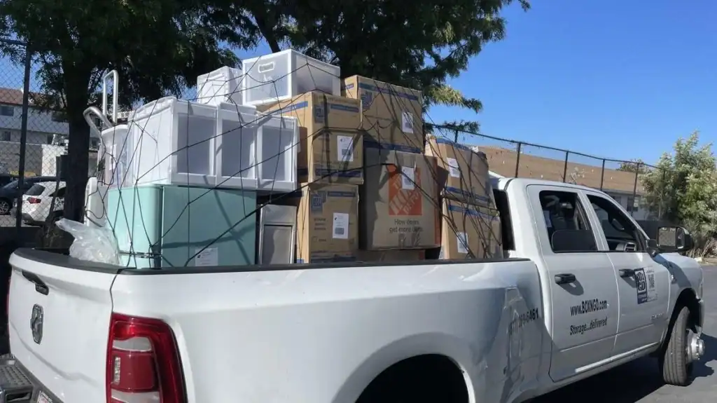 Pickup truck from a local moving company in Encino loaded with packed boxes and storage bins, showing efficient residential moving and delivery services in the Encino area.