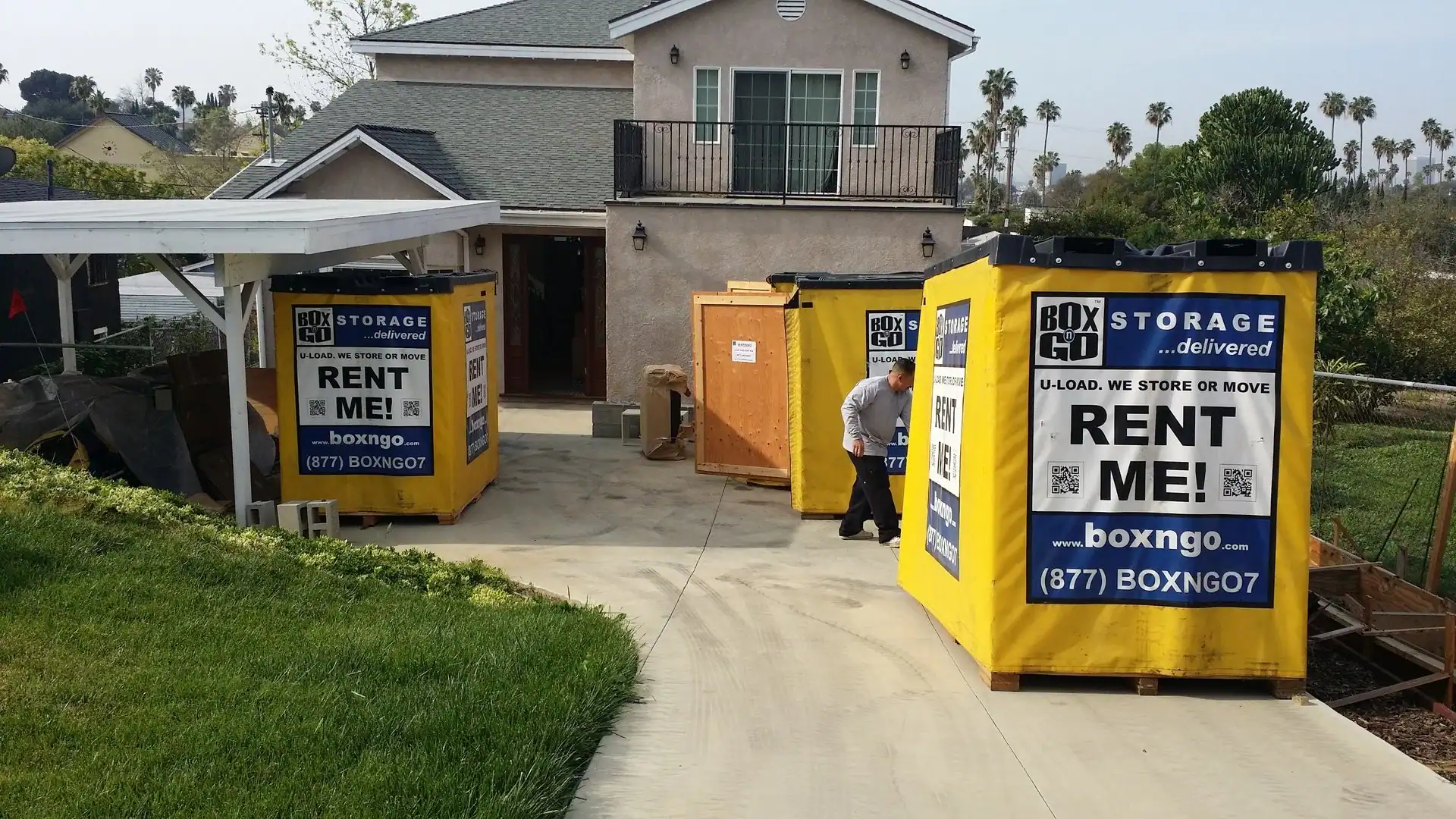 Residential driveway with Box-n-Go portable units for storage container rental Santa Monica, offering convenient and flexible moving and storage solutions.