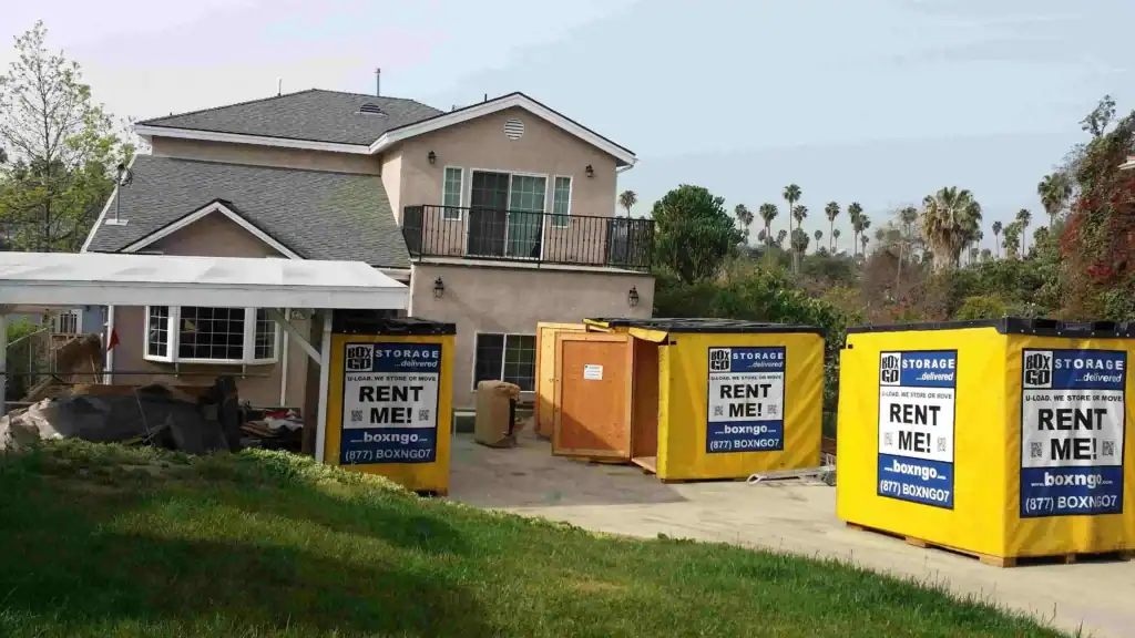 Residential property with multiple yellow Box-n-Go self storage units in Canyon Country CA, placed on the driveway for convenient temporary storage during a home renovation.