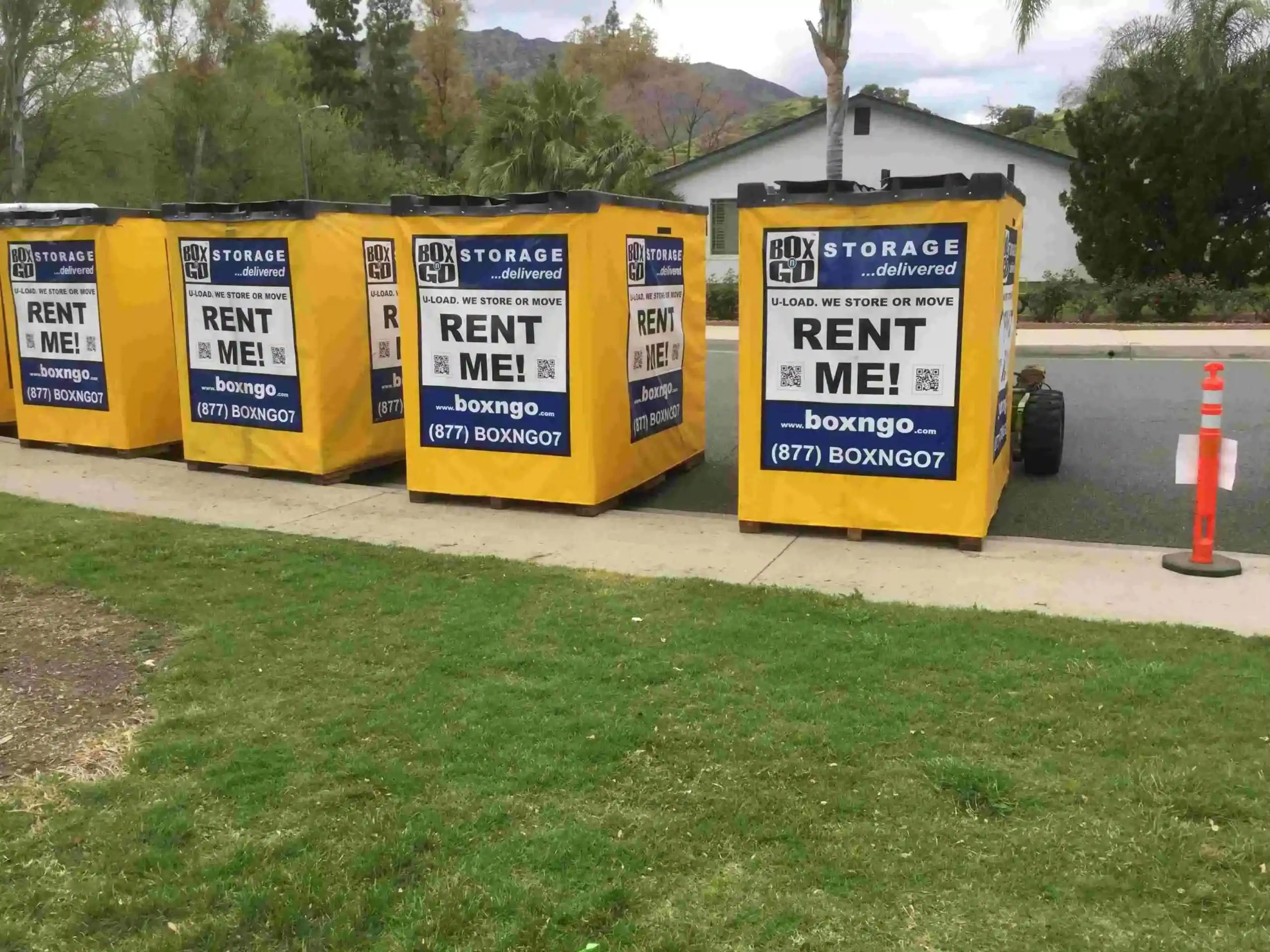 Row of yellow Box-n-Go portable containers lined up on a suburban street, showcasing convenient and affordable Self Storage Units in Canoga Park CA for moving, renovation, and home storage needs.