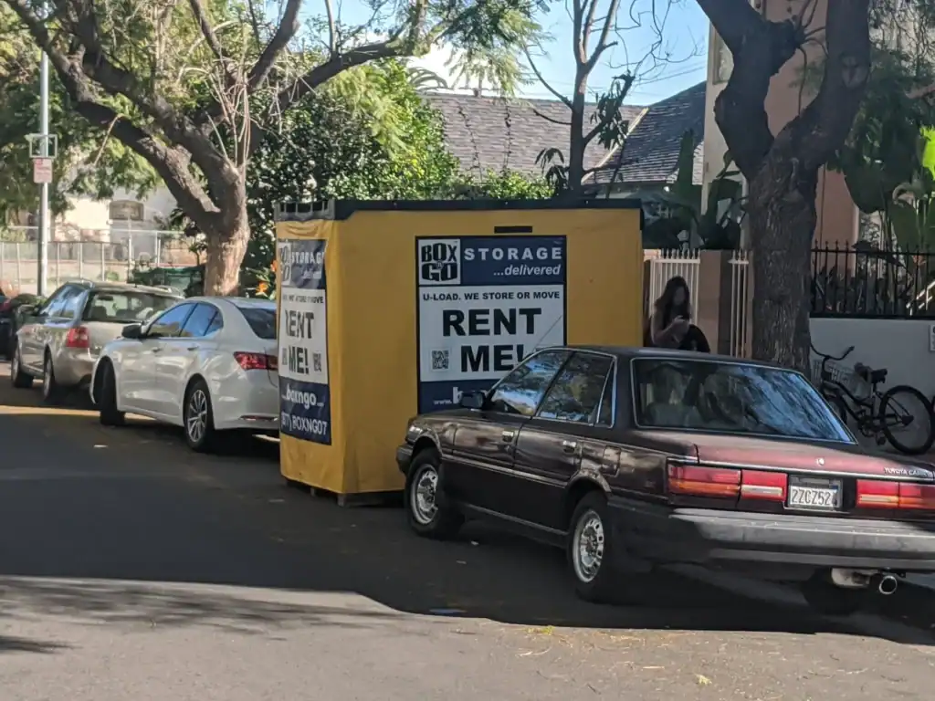 Temporary storage in Valley Glen featuring a Box-n-Go storage container placed on a residential street, surrounded by parked cars and trees, ideal for local moving or short-term storage solutions."Let me know if you want variations for different platforms (Google Images, social media, etc.) or a meta description to go with it
