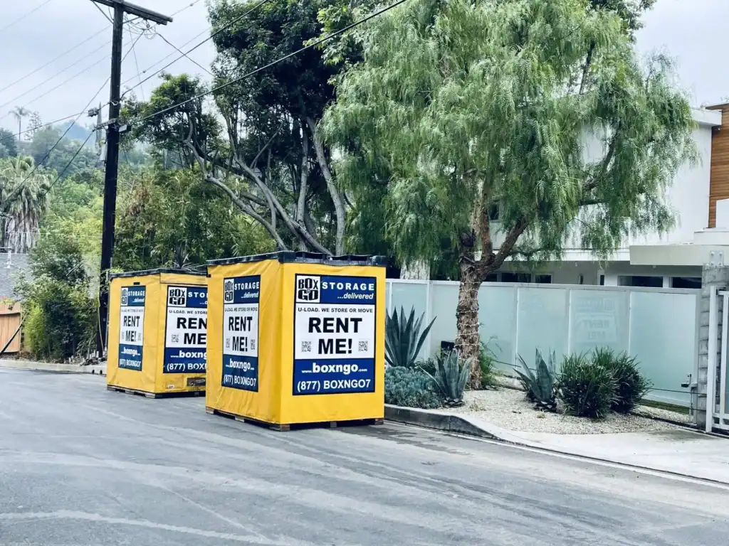 Three Box-n-Go portable storage containers offering temporary storage in Valley Glen, placed curbside in a residential neighborhood with modern homes and lush greenery.