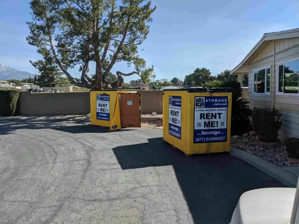 Two Box-n-Go portable storage containers placed in a residential driveway under clear skies, representing the need for a permit for portable storage in Sherman Oaks homes.