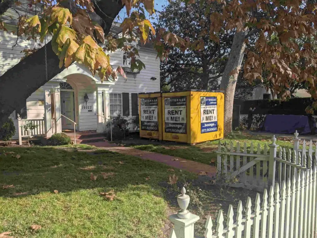 Two Box-n-Go portable storage containers placed in front of a Sherman Oaks home, showcasing reliable and affordable moving solutions from a trusted local moving company in Sherman Oaks.