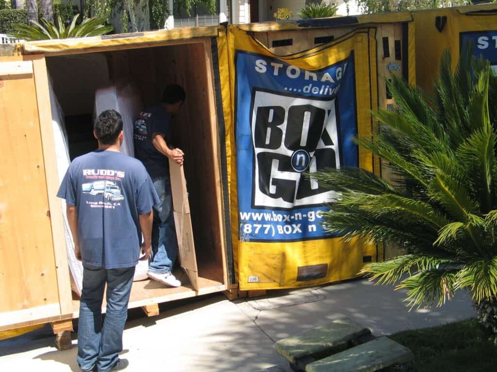Workers loading furniture into Box-n-Go portable unit for home renovation storage Santa Monica, providing secure and convenient storage during remodeling.
