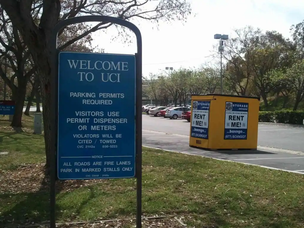 Yellow moving container from Boxngo with 'Rent Me' signage placed in a parking lot near UCI, ideal for secure and convenient moving containers in Sherman Oaks and surrounding areas.