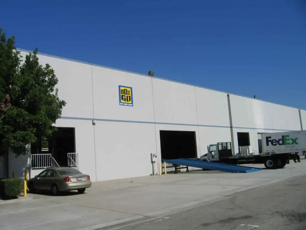 Storage Units Montrose Box-n-Go warehouse facility supporting portable storage Montrose services, with loading docks, delivery trucks, and a spacious industrial exterior.